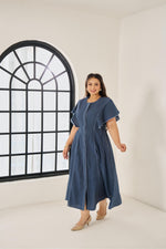 Load image into Gallery viewer, Light blue cotton Elara dress with subtle piping, ruffled cap sleeves, concealed buttons, and adjustable back belt for a flattering plus-size fit
