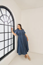 Load image into Gallery viewer, Light blue cotton Elara dress with subtle piping, ruffled cap sleeves, concealed buttons, and adjustable back belt for a flattering plus-size fit
